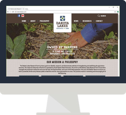 A desktop monitor showing the Dakota Lakes website